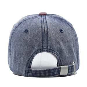 Detail view of washed denim baseball cap with adjustable silver metal buckle and strap
