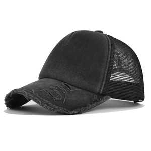 Close-up of distressed brim and mesh panel on a vintage style black trucker hat