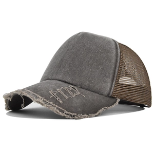 Detailed side view of distressed gray trucker hat with breathable brown mesh and embroidery