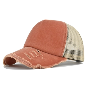 Close-up of distressed cotton canvas and mesh trucker hat with vintage frayed edges
