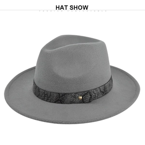 Close-up of grey wool fedora hat featuring snake pattern band and gold rivet detail
