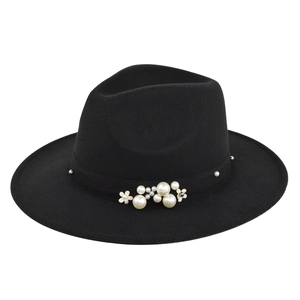 Close-up of black wool fedora featuring decorative faux pearls and golden flower accents