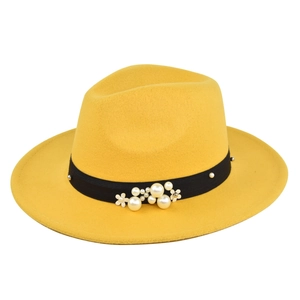 Detail of yellow wool fedora hat featuring black ribbon with pearls and white floral accents