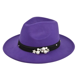 Detail of purple fedora hat featuring decorative pearls and floral accents on black band