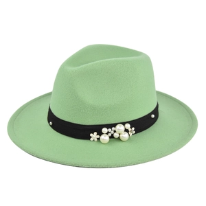 Detail of light green wool jazz hat with elegant pearl and flower decorative band