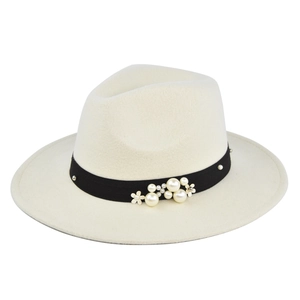 Detail of off-white wool fedora with black ribbon featuring pearl and gold floral accents
