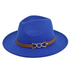 Macro detail of royal blue fedora hat with brown leather band and gold metal chain
