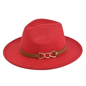 Detail of red wool fedora hat featuring a brown leather band and gold chain buckle