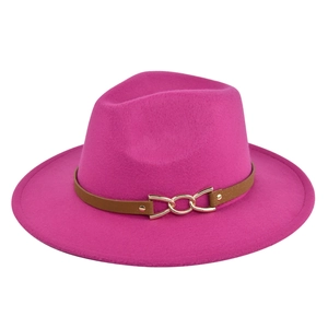 Detail of fuchsia wool fedora hat featuring a brown leather band and gold metal buckle