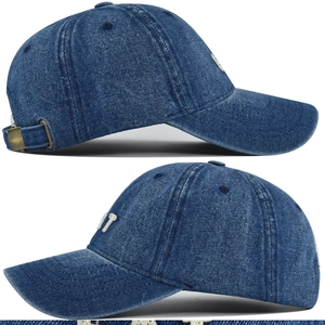 Detailed side view of washed blue denim baseball cap with white 3D embroidery and metal buckle