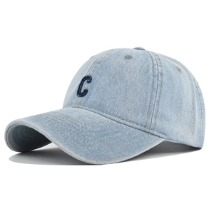 Detail of light blue denim baseball cap featuring navy blue 3D embroidered C letter
