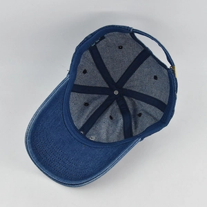 Detail of blue denim baseball cap interior showing stitching and adjustable buckle