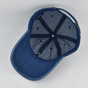 Inside view of washed denim baseball cap showing six-panel stitching and metal buckle