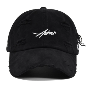 Detail of black distressed baseball cap with Asher embroidery and metal ring accent