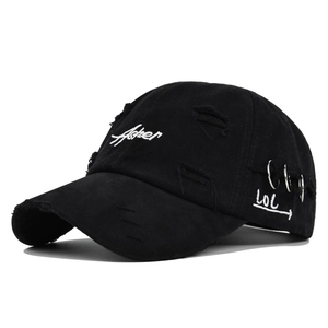 Detail of distressed black baseball cap with Asher embroidery and metal ring accents