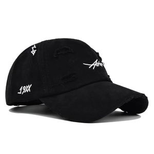 Close-up of vintage black washed cotton baseball cap with distressed edge and white embroidery
