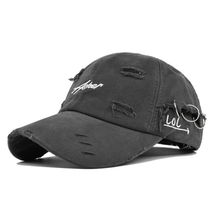 Detail showing distressed washed grey canvas with Fisher embroidery and metal rings on brim