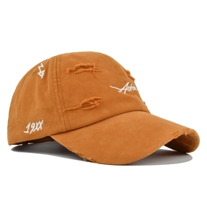 Detailed view of the distressed camel baseball cap with white Asher embroidery