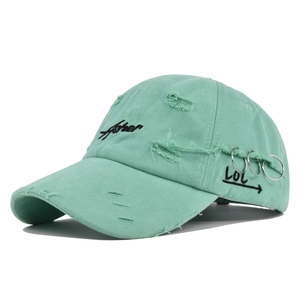 Distressed mint green Asher baseball hat with vintage embroidery and metal ring details