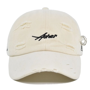 Detail showing distressed holes and cursive Asher embroidery on cream baseball cap