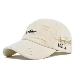 Close-up of beige distressed baseball cap with Asher embroidery and metal rings decoration