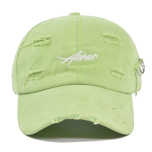 Detail of distressed mint green Asher cap with ripped holes and silver metal rings