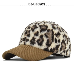 Detail view of leopard print plush fabric and brown corduroy brim on a baseball cap