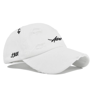 Close-up of distressed white baseball cap with Asher embroidery and vintage torn details