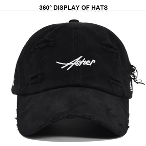 Detail of distressed black baseball cap with Asher embroidery and silver metal ring