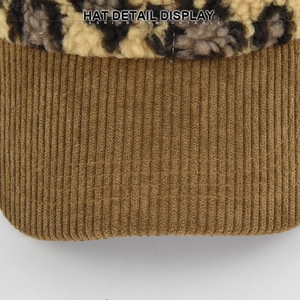 Detailed close-up of corduroy brim and leopard print faux fur texture on baseball cap