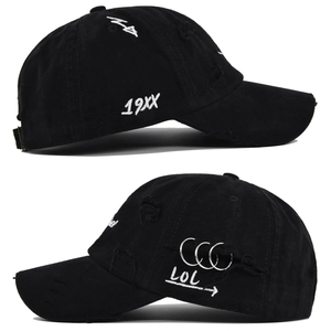 Detailed embroidery on distressed black baseball cap with metal rings and 19XX text