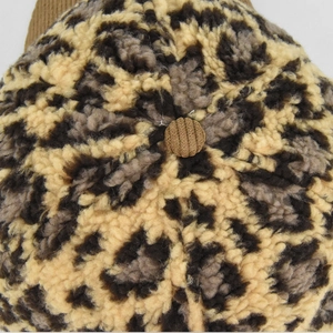 Detail of leopard print fleece baseball cap with brown corduroy top button detail
