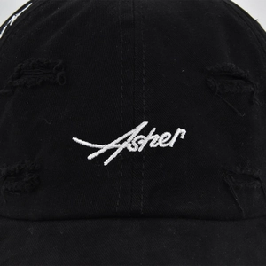 Distressed black cotton baseball cap with white Asher cursive embroidery and vintage details