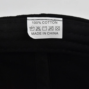 Close-up detail of the 100% cotton fabric and washing care label on this Asher baseball cap