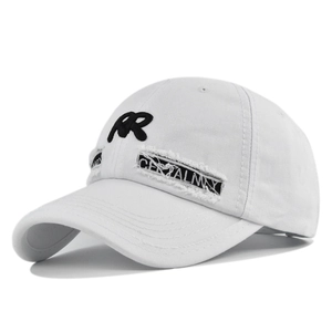 Close-up of white baseball cap with RR embroidery and distressed patchwork detailing