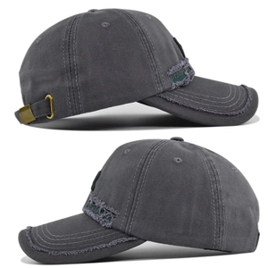Detail view of charcoal gray washed baseball cap with frayed edges and brass buckle