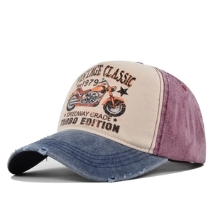 Detail of distressed brim and vintage motorcycle print on washed patchwork baseball cap