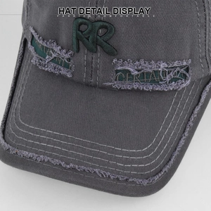 Close-up of gray vintage baseball cap featuring green RR embroidery and distressed details