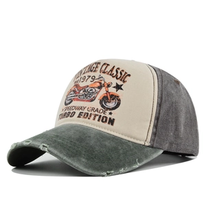 Detail of vintage baseball cap featuring distressed brim and retro motorcycle graphic print