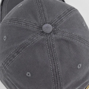 Close-up of gray cotton twill baseball cap crown with reinforced stitching and eyelets