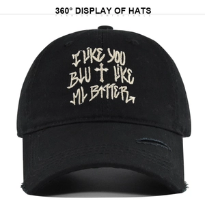 Black distressed cotton baseball cap with white cross embroidery and slogan detail