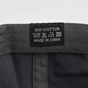 Close-up of 100% cotton fabric label with washing instructions on the baseball cap
