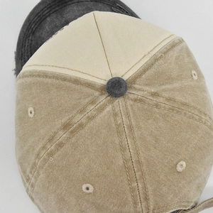 Close-up of vintage washed canvas baseball cap with detailed stitching and bicolor design