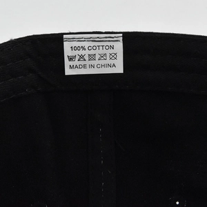 Detail view of cotton care label showing 100% Cotton material and Made in China text