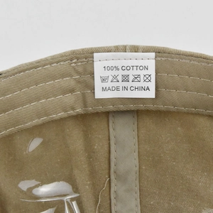 Close-up of the 100% cotton wash label and internal stitching on the baseball cap