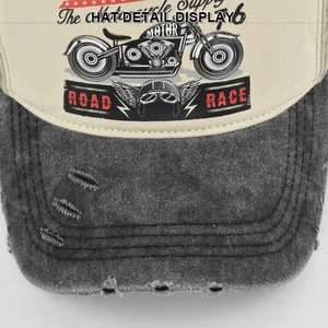 Close-up detail of vintage motorcycle print and distressed brim on the baseball cap