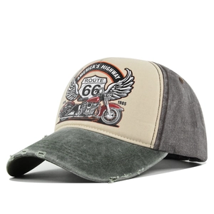 Detail of distressed brim and vintage Route 66 motorcycle print on a washed trucker hat