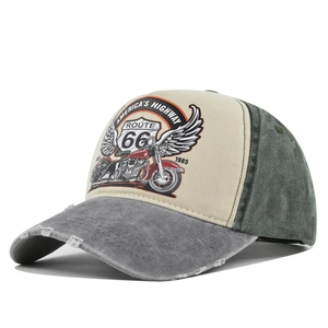 Detailed macro view of vintage Route 66 baseball cap showing washed fabric and distressed holes