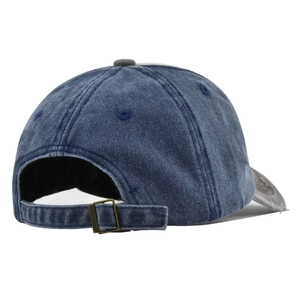 Detail view of washed denim baseball cap featuring vintage distressing and adjustable metal buckle