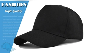 Detail view of the black cotton twill texture and stitching on a 5-panel baseball cap
